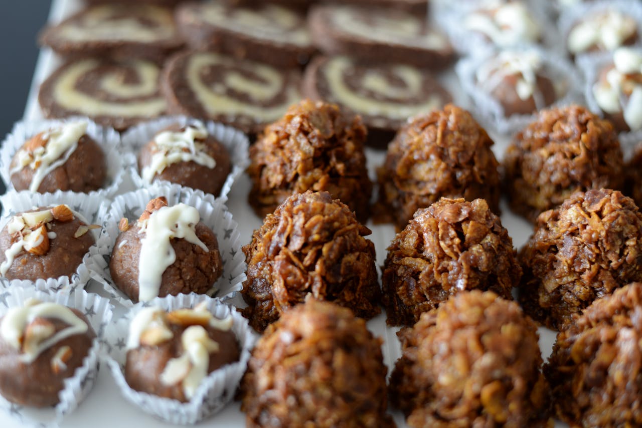 High angle of various tasty homemade bites and sweets placed on banquet table in cafe